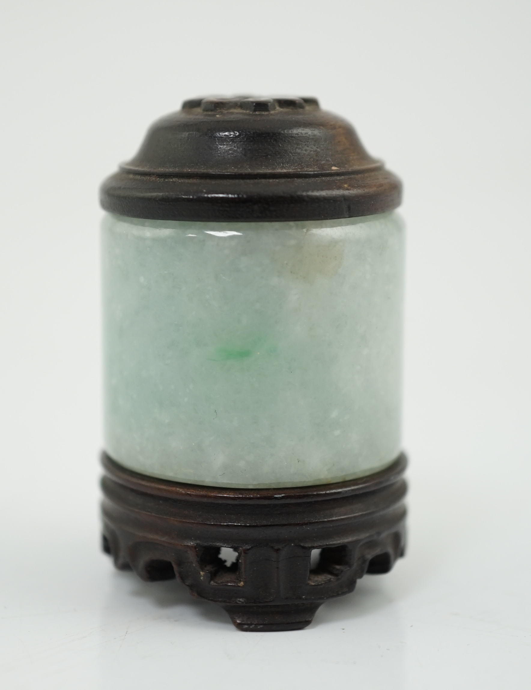 A Chinese jadeite archer's thumb ring, wood stand and cover, 19th century